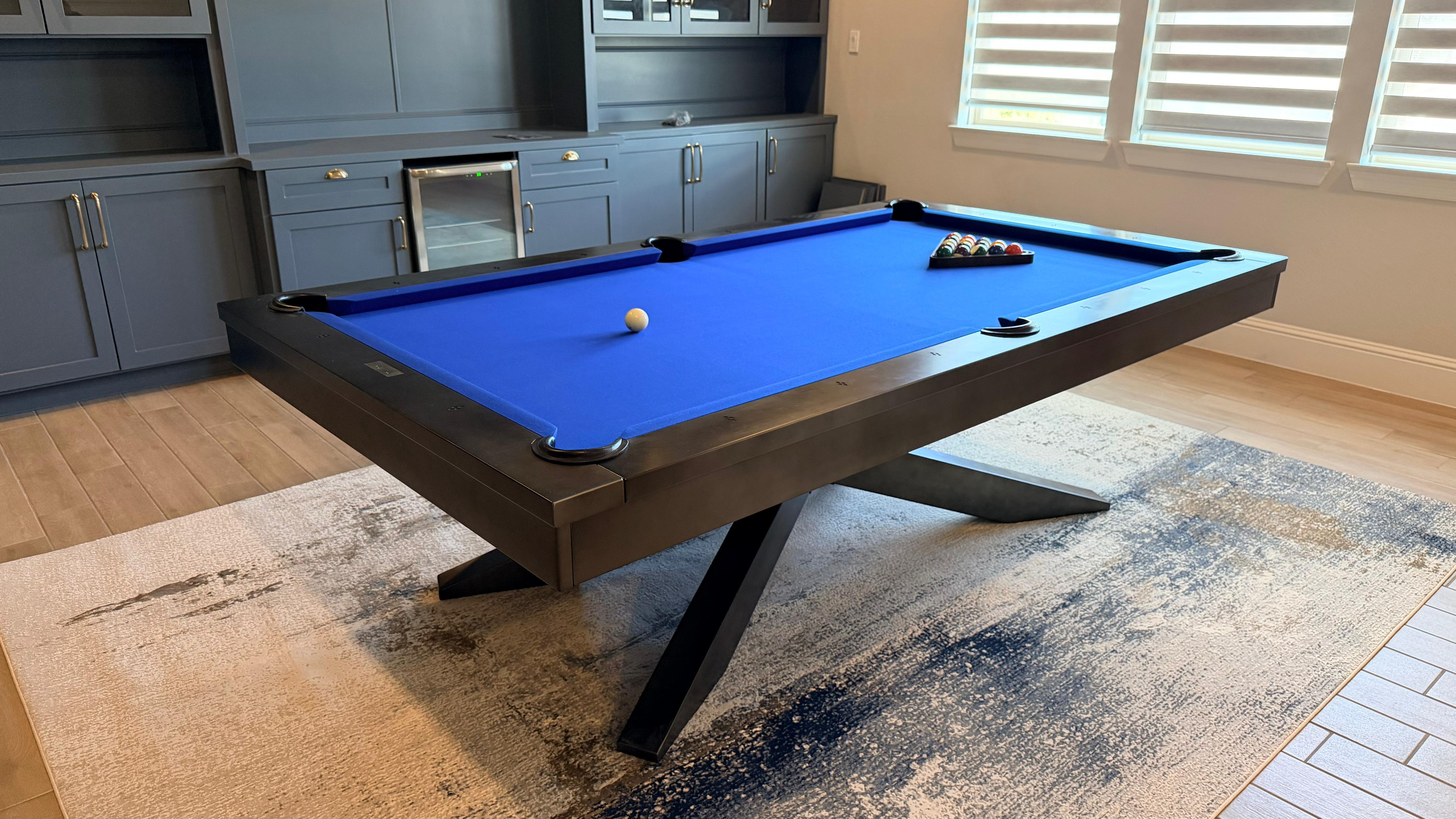 Blue felt pool table in home